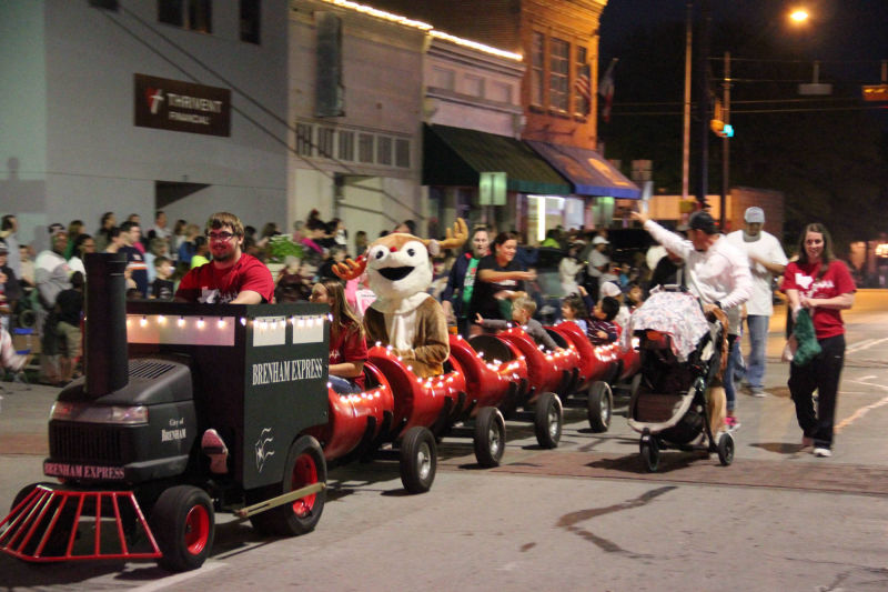 barrel train with city staff passing out candy - Frosty and Rudolph and kids sitting in barrels